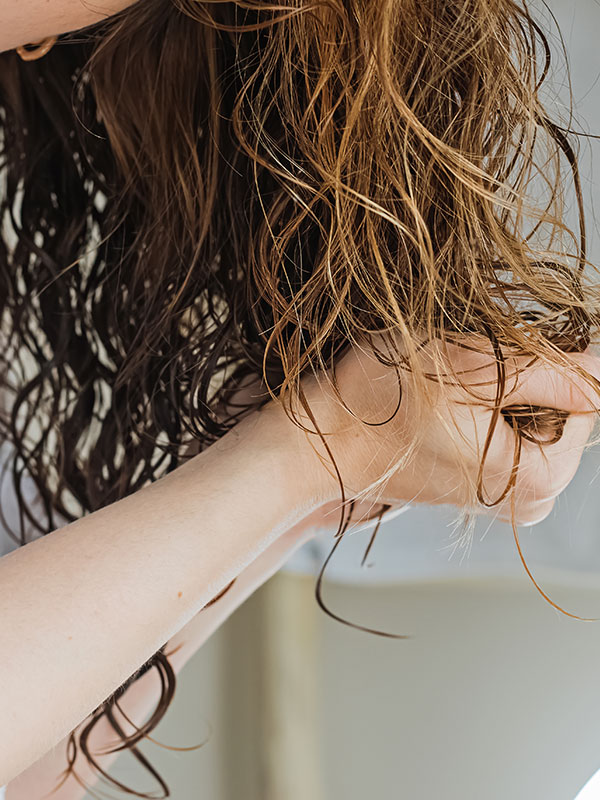 Lady washing curly hair